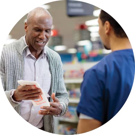 A patient picking up a prescription at the pharmacy.