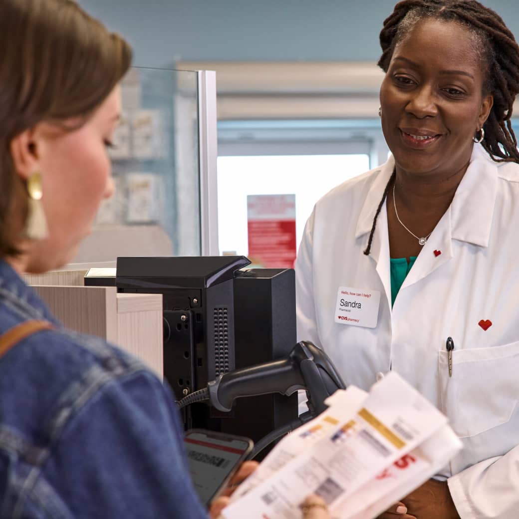 A patient looking at prescriptions just handed to them by a CVS pharmacist.
