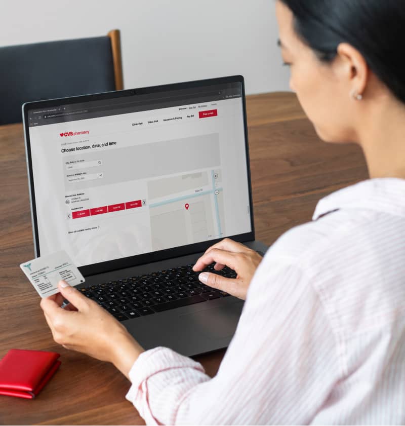 A person entering information online on the CVS Pharmacy site.